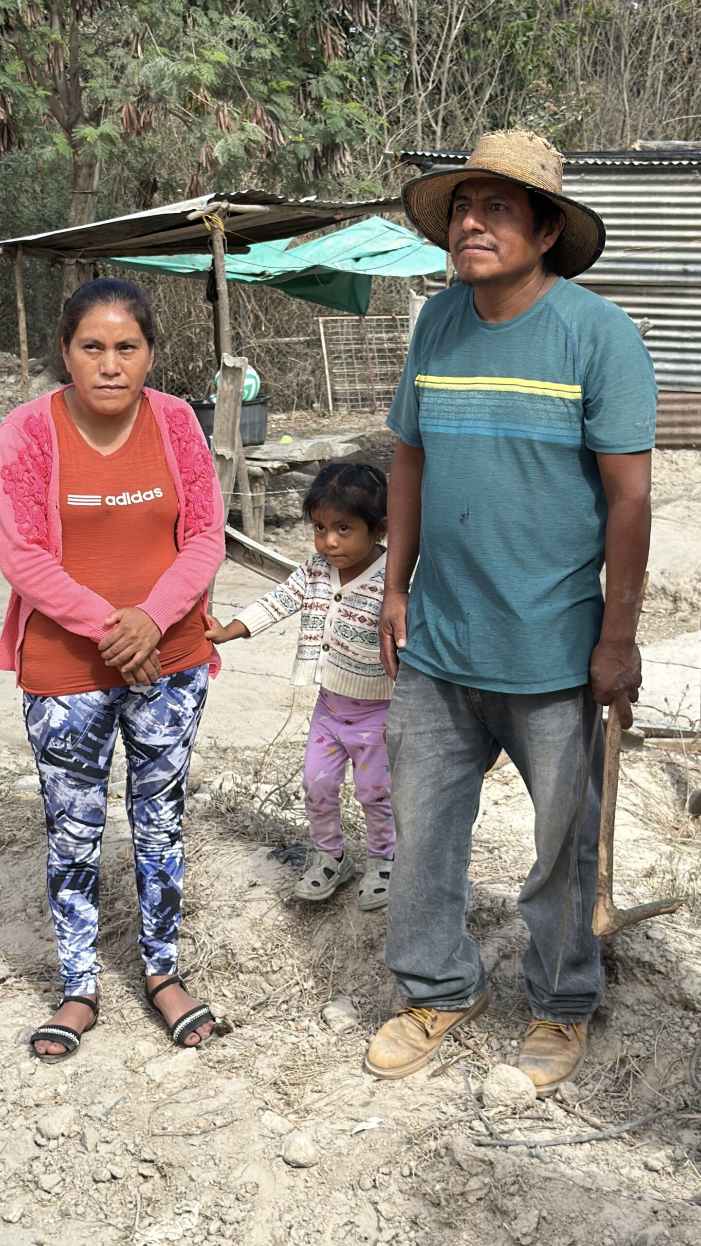William, Elvira and their daughter outside their shelter